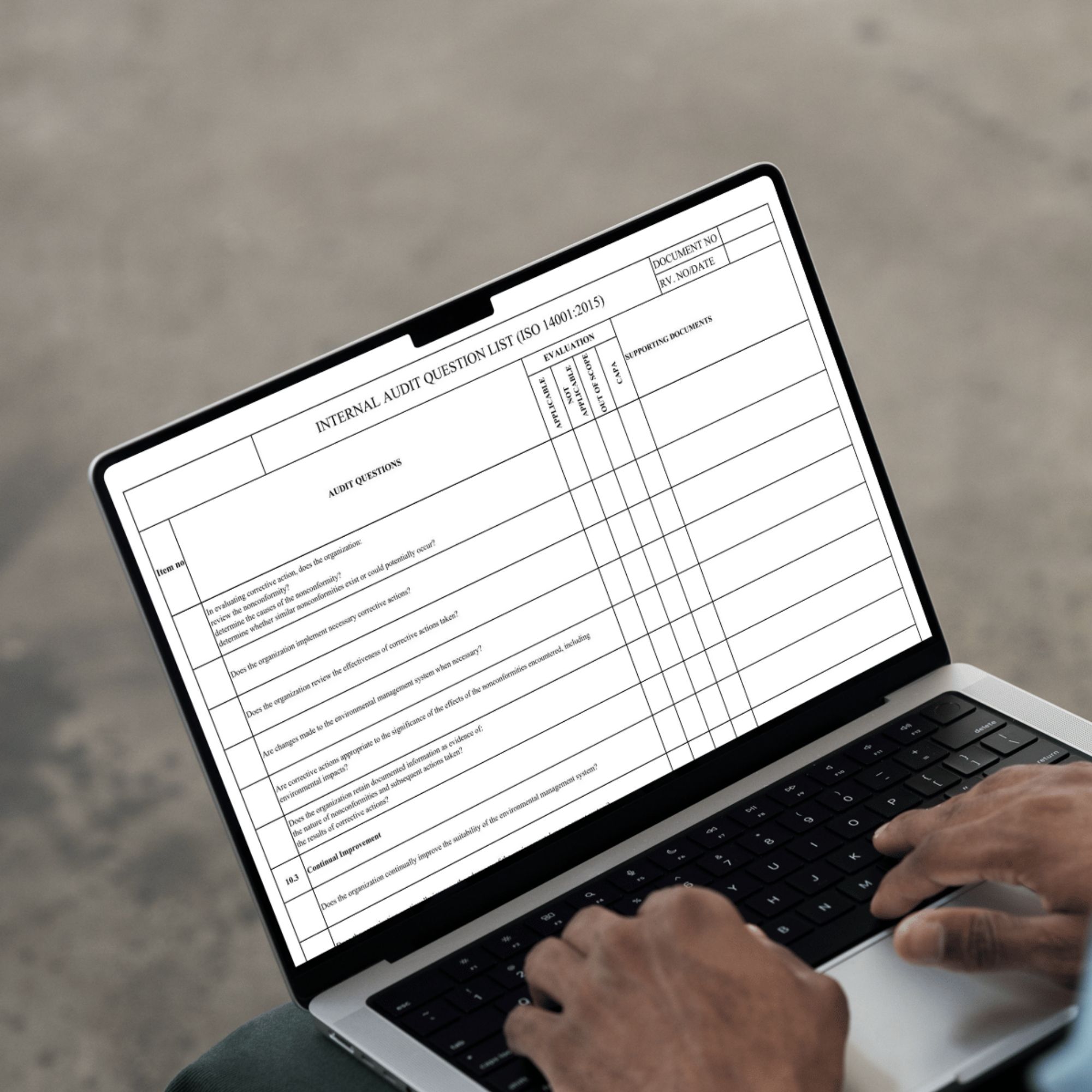 ISO 14001 internal audit checklist Excel template used on laptop for compliance auditing
