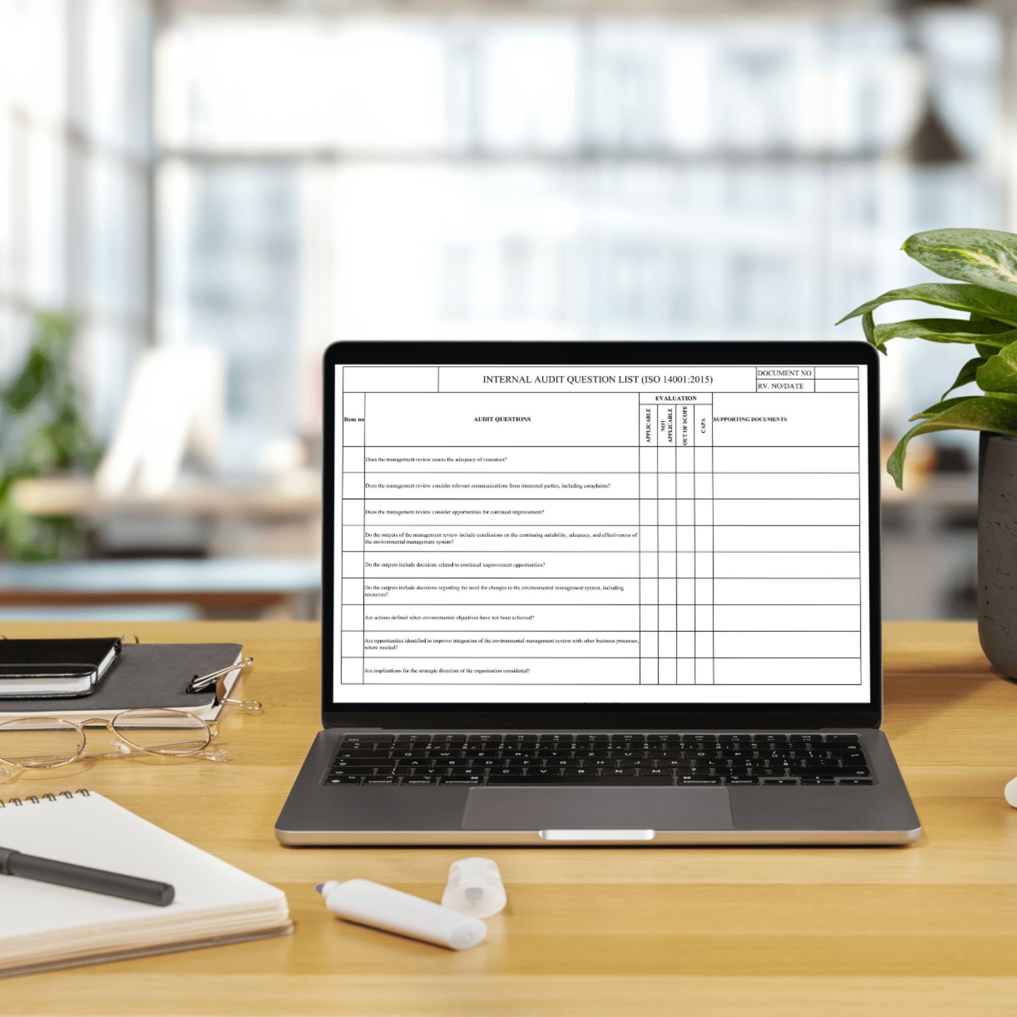 ISO 14001 audit checklist displayed on laptop workspace for environmental audit review